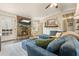 Comfortable living room featuring a stone fireplace, ceiling fan, and plush blue seating at 411 Buckingham Cir, Marietta, GA 30066