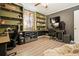 Home office with built-in shelves, laminate floors, dual desks, and comfortable seating at 411 Buckingham Cir, Marietta, GA 30066