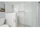 Modern walk-in shower showcases marble-style tile, glass doors, a rainfall showerhead, and a niche at 411 Buckingham Cir, Marietta, GA 30066