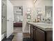 Bathroom vanity featuring granite counters, wood cabinets, and view into the bedroom at 7206 Begonia Way # 4, Austell, GA 30168