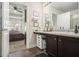 Bathroom with a vanity, dark wood cabinets, and a view into the bedroom at 7206 Begonia Way # 4, Austell, GA 30168