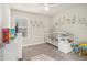 Bedroom with crib, changing table, and a window letting in natural light at 7206 Begonia Way # 4, Austell, GA 30168
