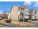 View of a well-maintained townhome showcasing a blend of siding and brick, highlighted by a charming balcony at 7206 Begonia Way # 4, Austell, GA 30168
