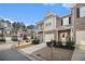 Street view of inviting townhomes with attached garages, quaint balconies, and well-maintained landscaping at 7206 Begonia Way # 4, Austell, GA 30168
