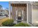 Inviting front door with glass panels, complemented by brick columns and manicured greenery at 7206 Begonia Way # 4, Austell, GA 30168