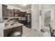 Dark kitchen with granite countertops, tile backsplash and modern appliances including black fridge at 7206 Begonia Way # 4, Austell, GA 30168