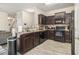 Dark kitchen with granite countertops, tile backsplash and modern appliances including black dishwasher and oven at 7206 Begonia Way # 4, Austell, GA 30168