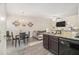 Open-concept living space with kitchen, dining room and living room with gray sofa and tile floors at 7206 Begonia Way # 4, Austell, GA 30168