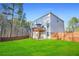 The backyard with a well-maintained lawn, a deck with an umbrella and a wooden fence at 13699 Inman Rd, Hampton, GA 30228