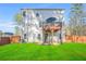 The backyard with a well-maintained lawn, a deck with an umbrella and a wooden fence at 13699 Inman Rd, Hampton, GA 30228