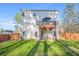 The backyard with a well-maintained lawn, a deck with an umbrella and a wooden fence at 13699 Inman Rd, Hampton, GA 30228