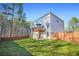 The backyard with a well-maintained lawn, a deck with an umbrella and a wooden fence at 13699 Inman Rd, Hampton, GA 30228