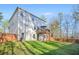 The backyard with a well-maintained lawn, a deck with an umbrella and a wooden fence at 13699 Inman Rd, Hampton, GA 30228