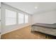 Bright bedroom with plush carpet and three windows providing natural light at 13699 Inman Rd, Hampton, GA 30228