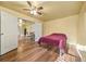 Bedroom featuring wood floors and a ceiling fan and a doorway to the dining room at 13699 Inman Rd, Hampton, GA 30228