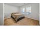 Cozy bedroom featuring a bed, neutral carpet, and a sunlit window with blinds at 13699 Inman Rd, Hampton, GA 30228