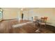 Dining room with wood floors, ceiling fan, and a round table with chairs at 13699 Inman Rd, Hampton, GA 30228