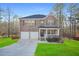 Charming two-story brick home featuring a two-car garage, covered porch, and manicured lawn at 13699 Inman Rd, Hampton, GA 30228