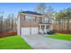 Beautiful brick home boasts a two-car garage, welcoming porch, and well-maintained landscaping at 13699 Inman Rd, Hampton, GA 30228