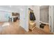 Inviting foyer with coat rack and bench leading to the kitchen and nearby bathroom at 13699 Inman Rd, Hampton, GA 30228