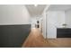 Long hallway features wood floors and neutral walls leading to rooms with modern decor at 13699 Inman Rd, Hampton, GA 30228