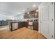 Spacious kitchen featuring stainless steel appliances and dark cabinets, seamlessly connecting to the living area at 13699 Inman Rd, Hampton, GA 30228