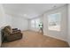 Comfortable living room with a recliner and bright windows at 13699 Inman Rd, Hampton, GA 30228