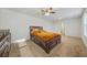 Primary bedroom with carpeting, ceiling fan, and a dark wooden bed frame with storage underneath at 13699 Inman Rd, Hampton, GA 30228