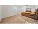 Primary bedroom featuring plush carpeting, a ceiling fan, and a large wooden bed frame at 13699 Inman Rd, Hampton, GA 30228