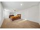 Primary bedroom with carpeting, ceiling fan and a dark wooden bed frame at 13699 Inman Rd, Hampton, GA 30228