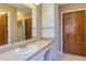 Bathroom with white sink and countertop, wood cabinets and drawers, and view of shower at 166 Muse Rd, Fayetteville, GA 30214
