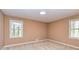 Cozy bedroom with carpeted floors and neutral colored walls, and windows offering backyard view at 166 Muse Rd, Fayetteville, GA 30214