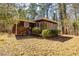 Charming home exterior showcasing a sunroom, with natural surroundings, and mature landscaping, and a serene ambiance at 166 Muse Rd, Fayetteville, GA 30214