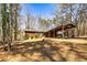 Exterior of home with carport and shrubbery in a wooded setting at 166 Muse Rd, Fayetteville, GA 30214