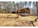 A wooded home with a screened-in porch and sloped yard at 166 Muse Rd, Fayetteville, GA 30214