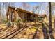 Wood and stone exterior with a well-manicured yard and a glimpse of a detached garage at 166 Muse Rd, Fayetteville, GA 30214