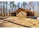 Stone and wood exterior of the home with mature trees and natural landscaping at 166 Muse Rd, Fayetteville, GA 30214