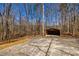 Detached garage with concrete driveway amid a heavily wooded area at 166 Muse Rd, Fayetteville, GA 30214