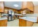 This kitchen features wood cabinetry, stainless appliances, and abundant counter space at 166 Muse Rd, Fayetteville, GA 30214