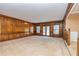 Spacious living room with wood-paneled walls and French doors leading to the outside at 166 Muse Rd, Fayetteville, GA 30214