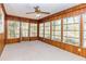 Enclosed sunroom featuring paneled walls, carpet floors, large windows providing natural light at 166 Muse Rd, Fayetteville, GA 30214
