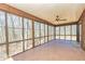 Relax in this bright sunroom with floor to ceiling windows, tile floors and a ceiling fan at 166 Muse Rd, Fayetteville, GA 30214