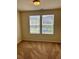 The bedroom has natural light from the two bright windows with neutral walls and carpeting at 2056 Belmont Cir, Conyers, GA 30012