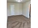 A large bedroom features neutral walls and carpeting, along with one white door at 2056 Belmont Cir, Conyers, GA 30012