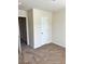 A bright bedroom features neutral walls, carpeting, and one white door at 2056 Belmont Cir, Conyers, GA 30012