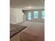 Bright living room with a staircase and a door that leads to the outside at 2056 Belmont Cir, Conyers, GA 30012