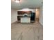 Open-concept living room with a kitchen island, black appliances, and neutral-toned carpeting at 2056 Belmont Cir, Conyers, GA 30012