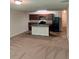 Combined living and kitchen area featuring dark cabinetry and black appliances at 2056 Belmont Cir, Conyers, GA 30012
