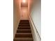 Carpeted staircase with white railing leading to upper level of the home at 2056 Belmont Cir, Conyers, GA 30012