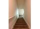 A carpeted staircase leads upward with a white handrail against neutral-toned walls at 2056 Belmont Cir, Conyers, GA 30012
